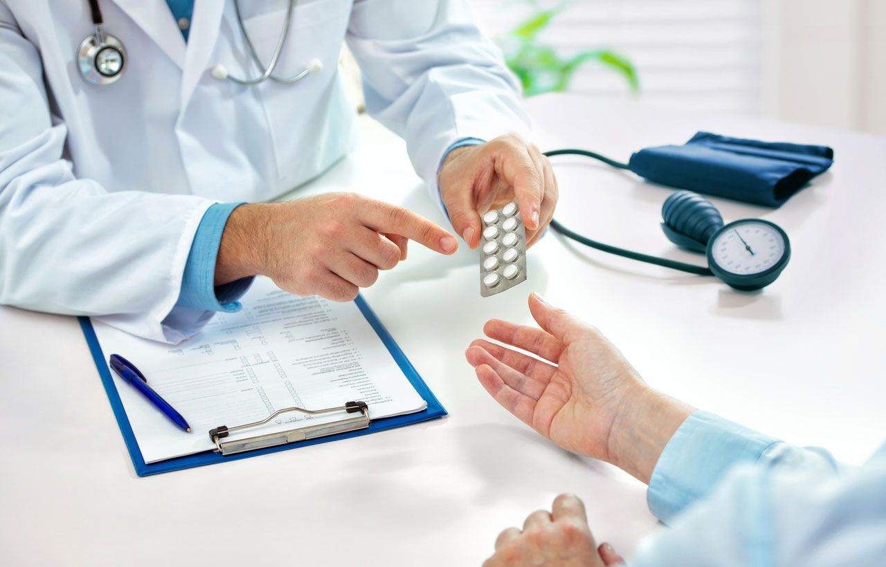 Image of a practitioner pointing to medicine